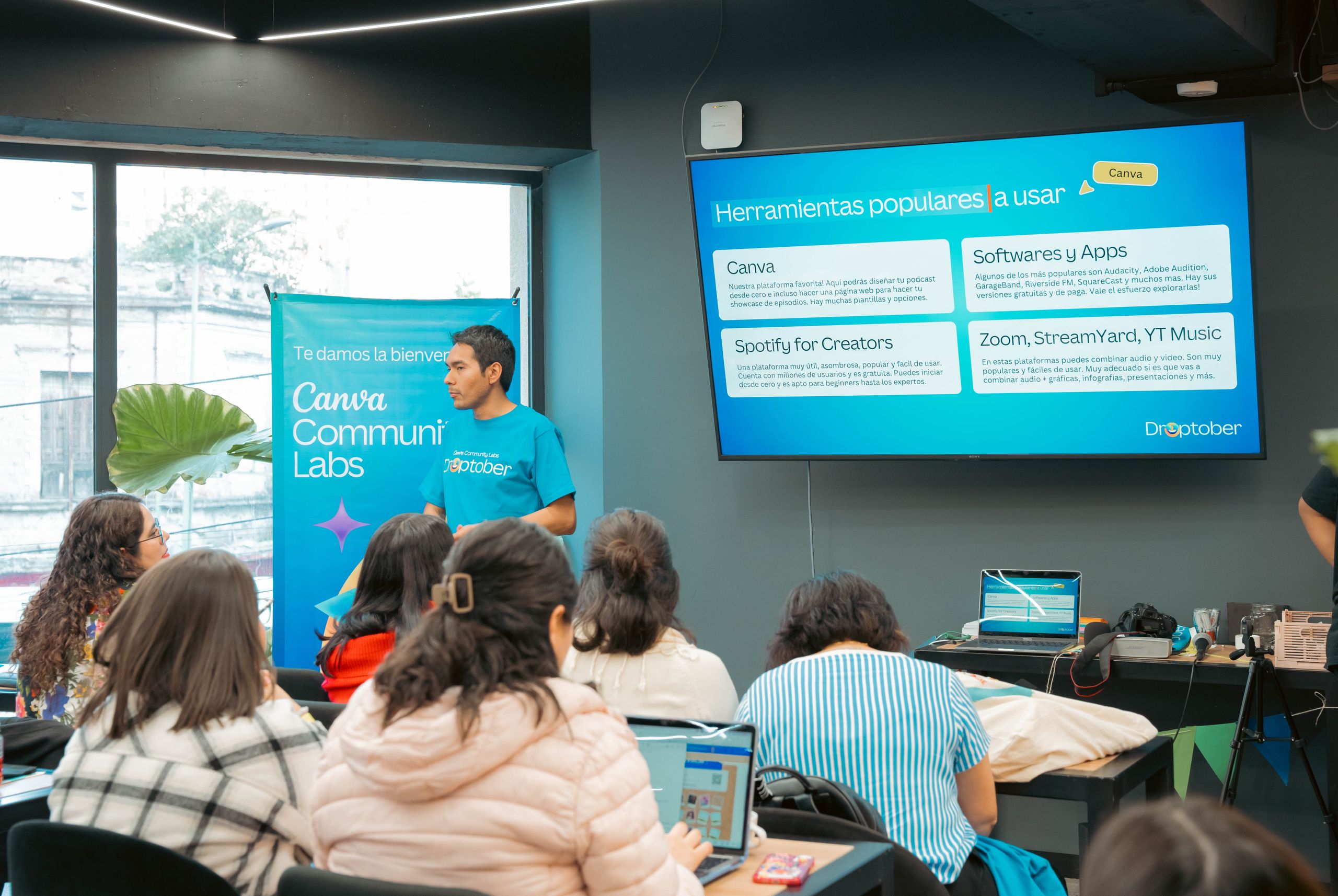 A speaker presenting technology tools in a workshop environment.